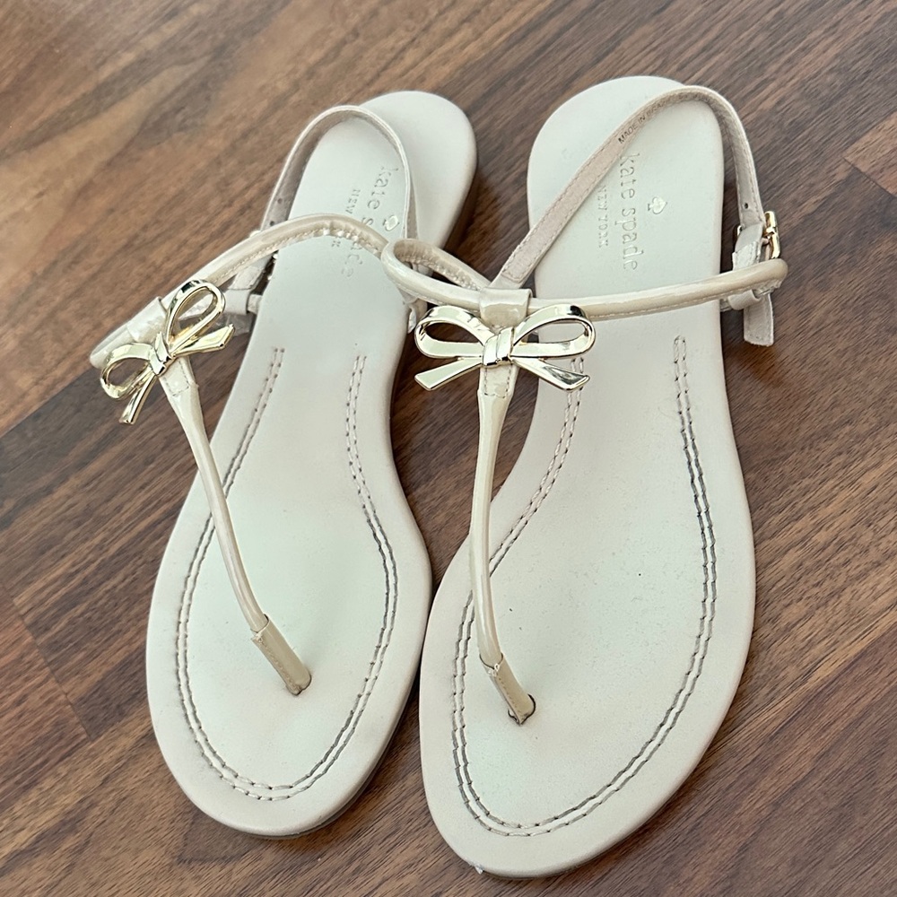 kate spade Cream Bow T-Strap Sandals with Gold Accent